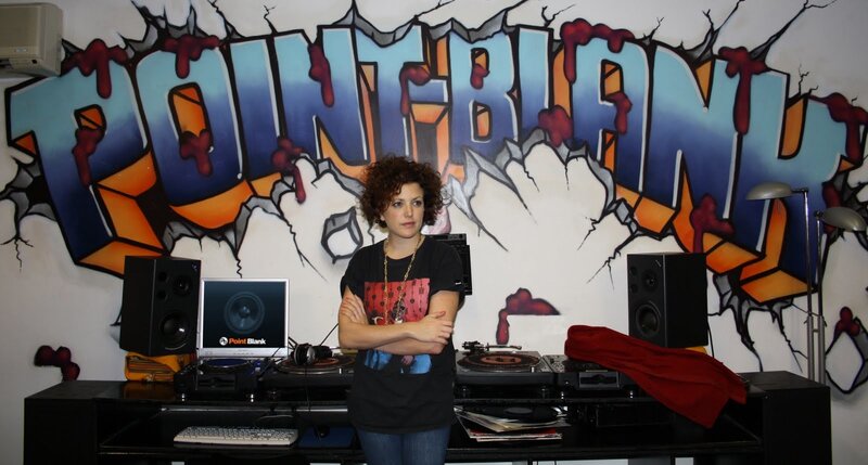 DJ in front of graffiti wall