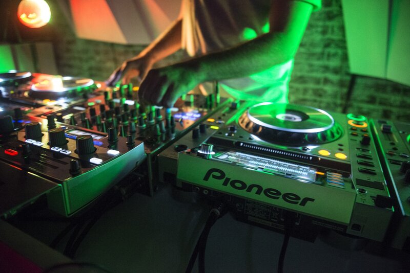 DJ Operating Turntables — Green