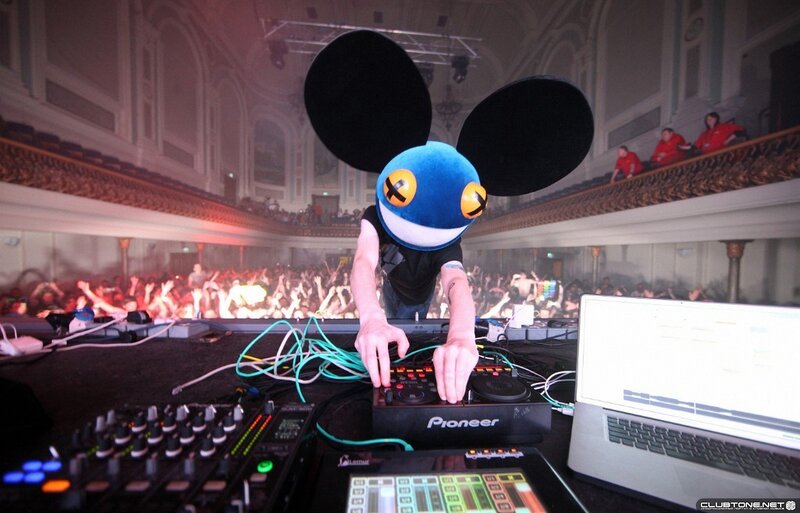 DJ Performing at Concert — Black, Energetic, Night, Photograph, Crowd, Laptop