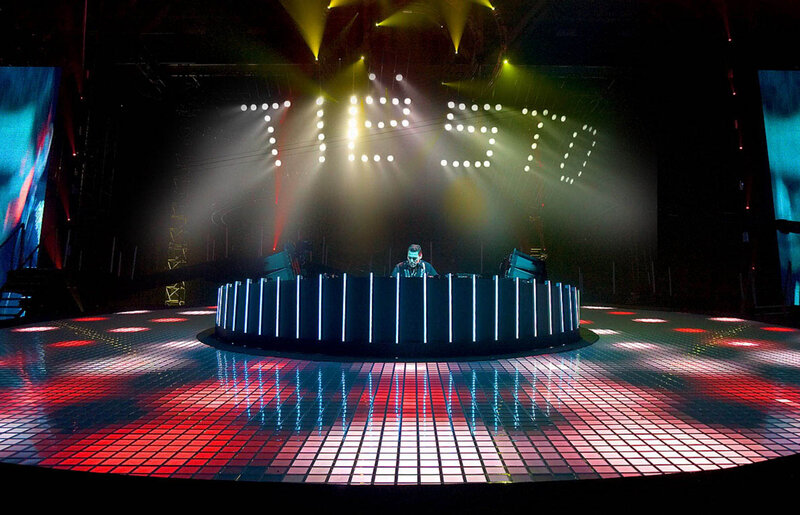 DJ performing on a lit stage