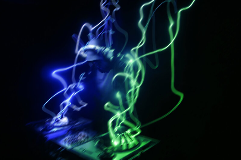 Dj performing with light trails