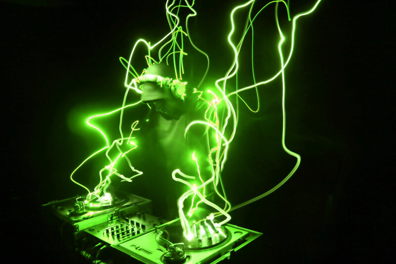 DJ performing with light trails