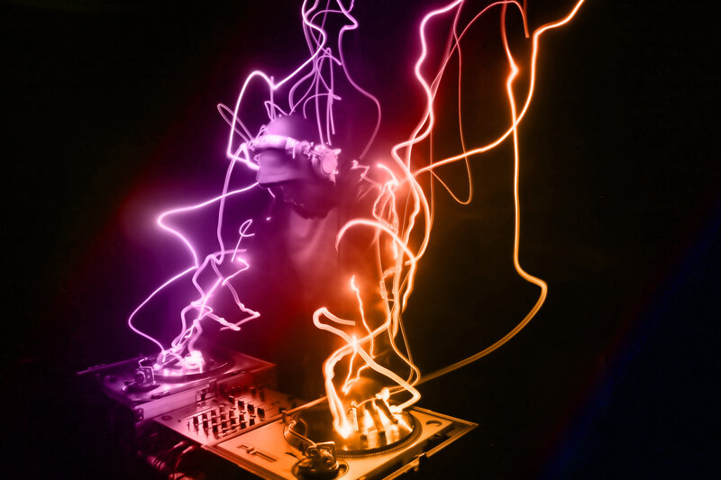 DJ performing with light trails