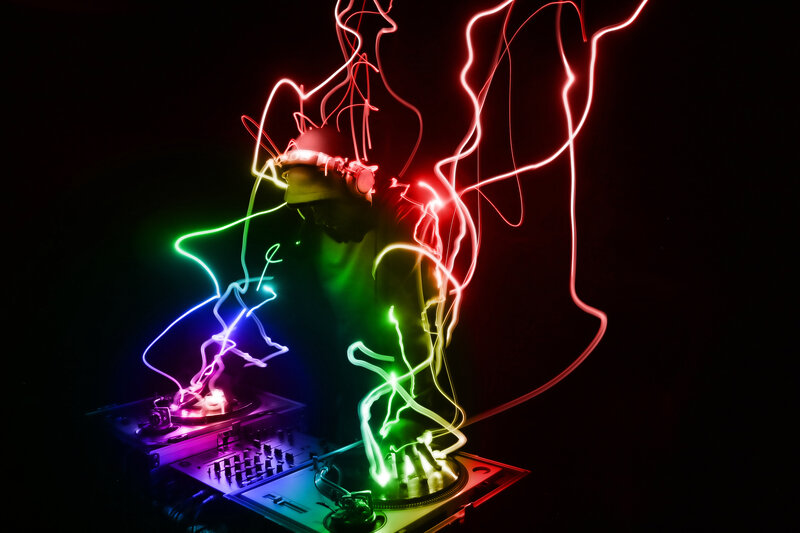 DJ performing with light trails