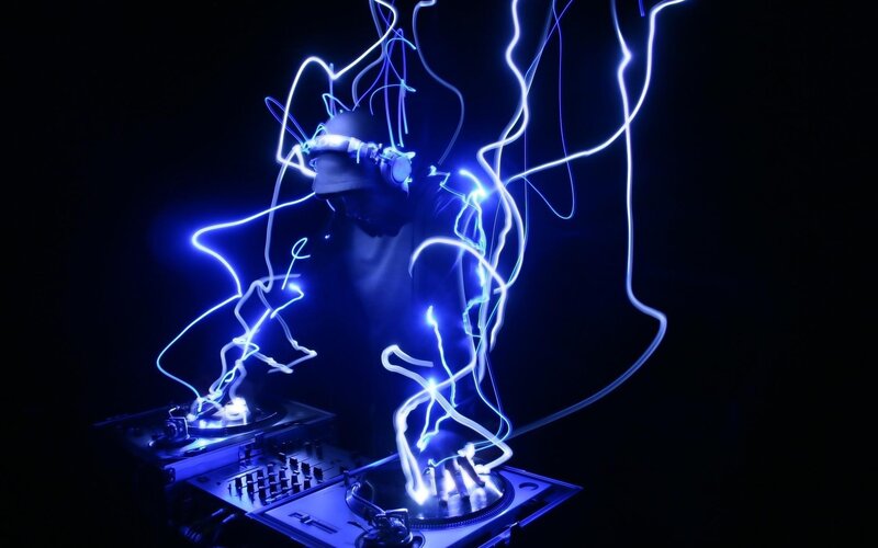 DJ performing with light trails