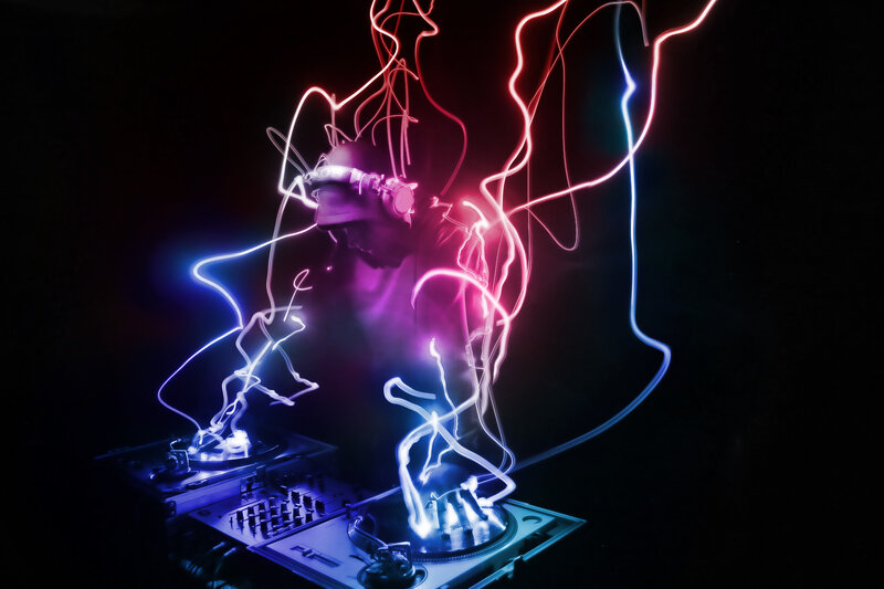 DJ performing with light trails