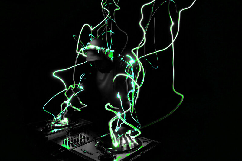 DJ performing with light trails