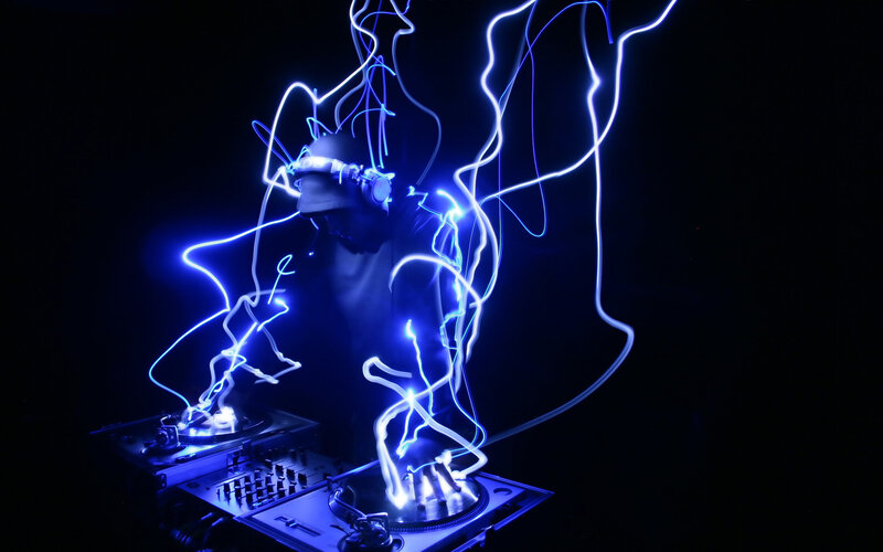 DJ performing with light trails