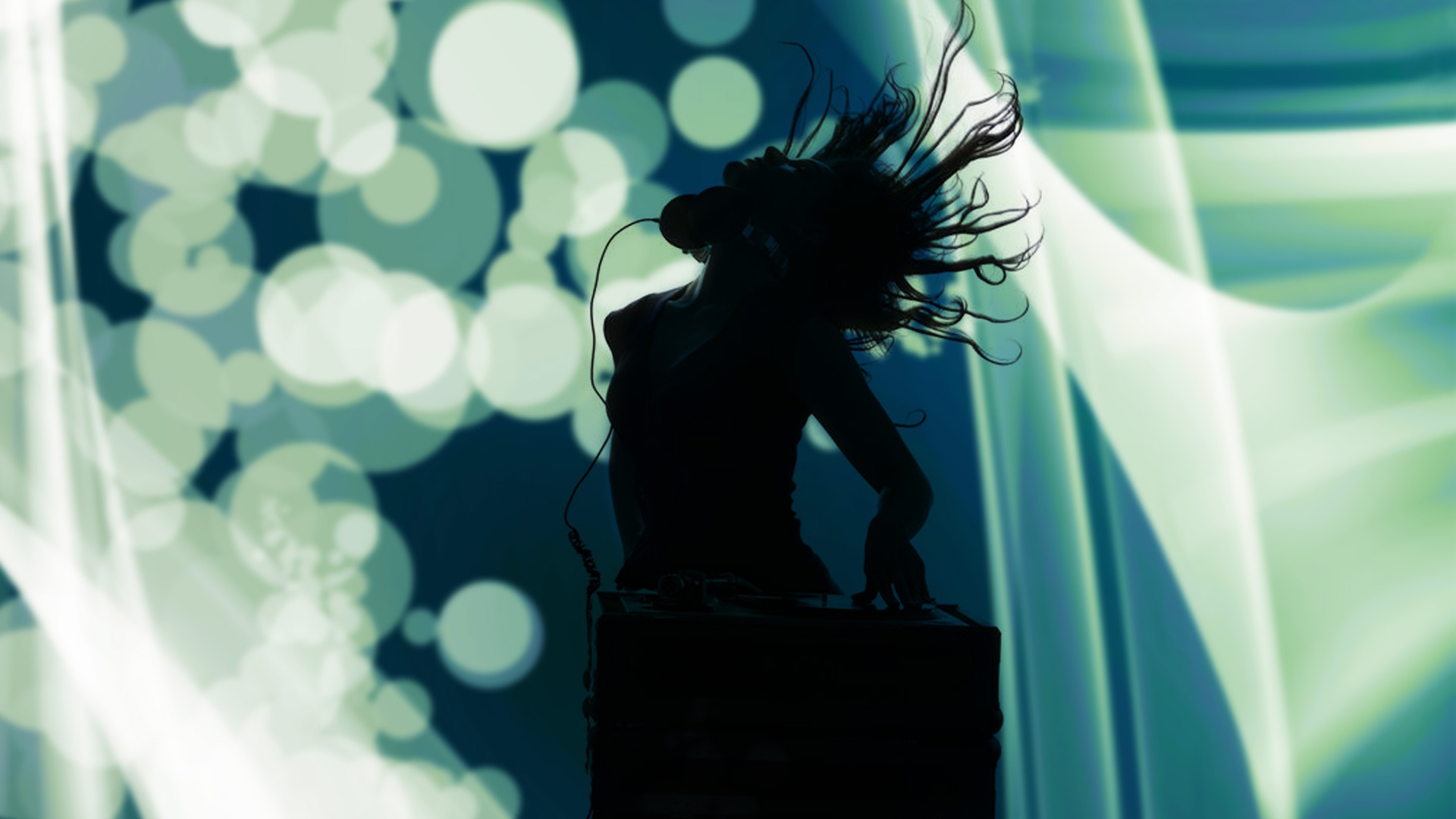 DJ silhouetted against lights