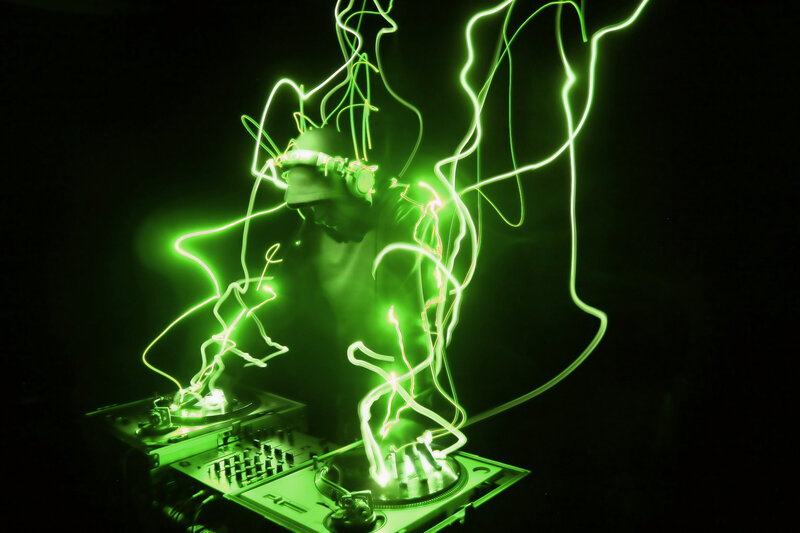 DJ with green light trails