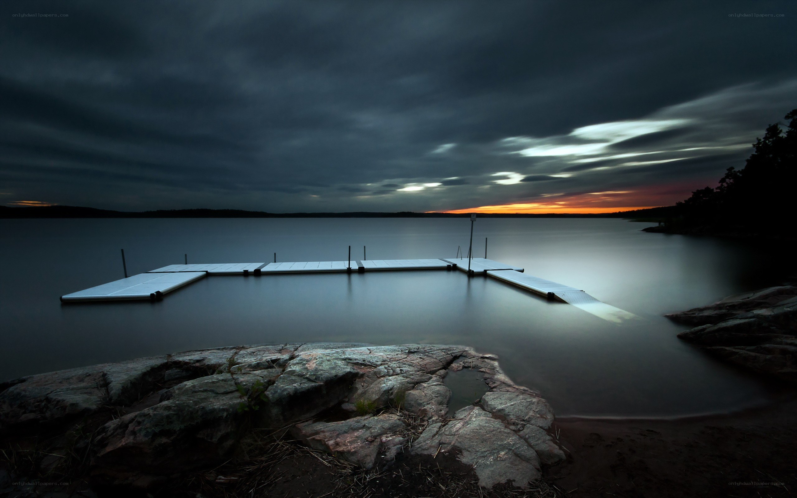 Dock at dusk with cloudy sky