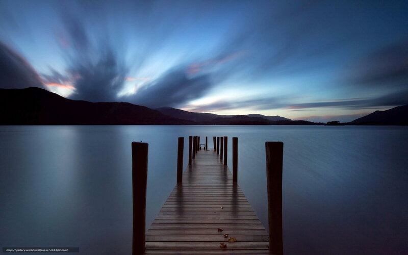 Dock at dusk with motion-blurred sky