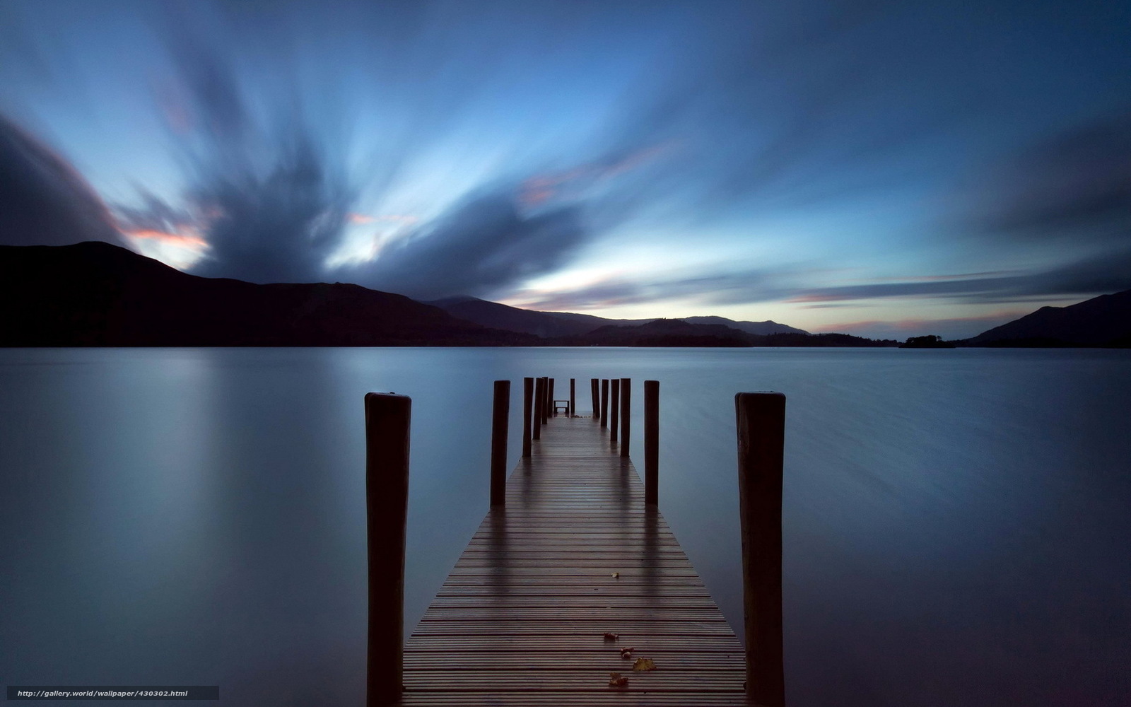 Dock at dusk with motion-blurred sky