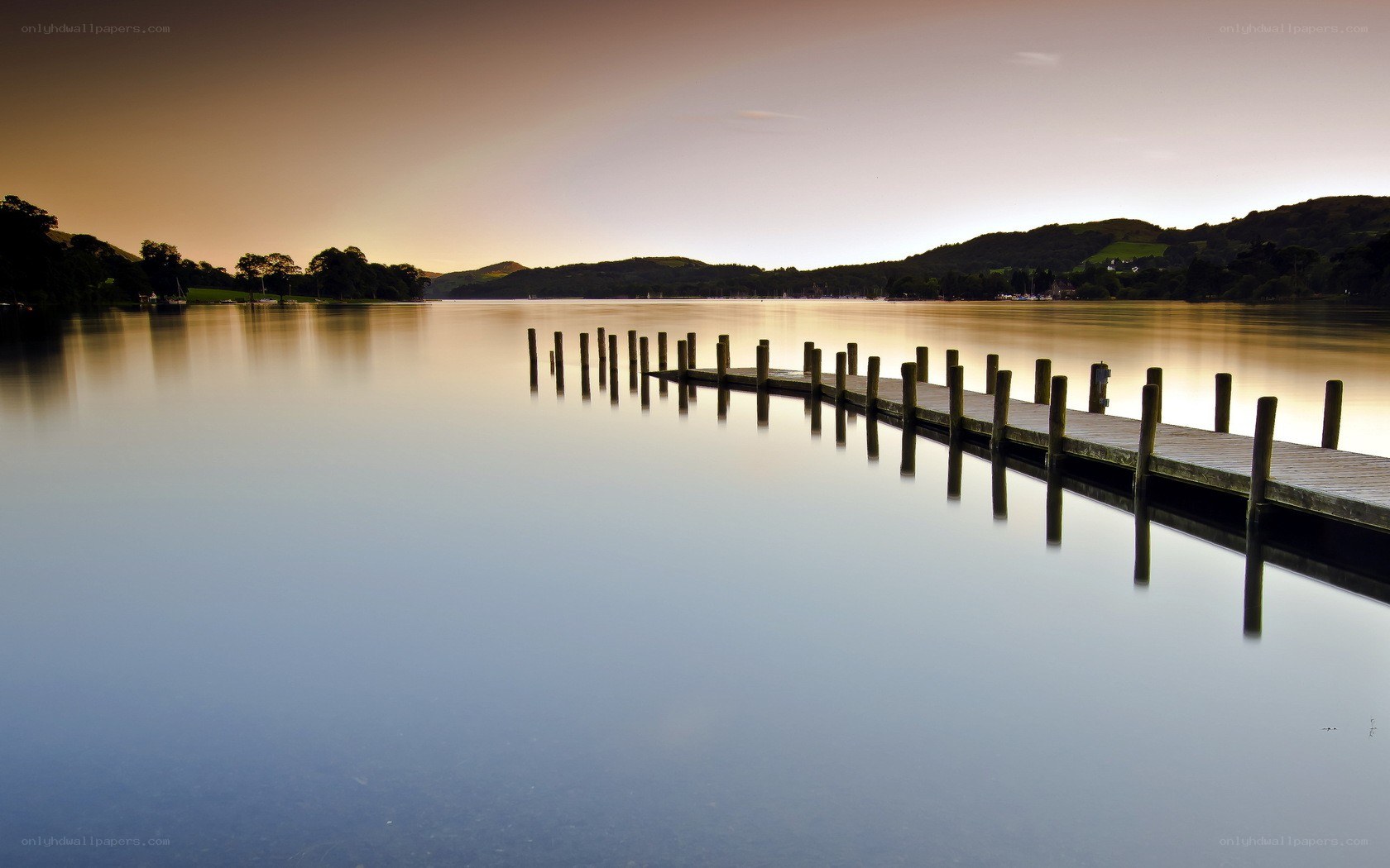 Dock at sunset on a calm lake
