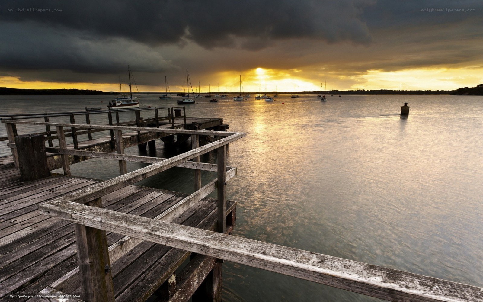 Dock at sunset with boats