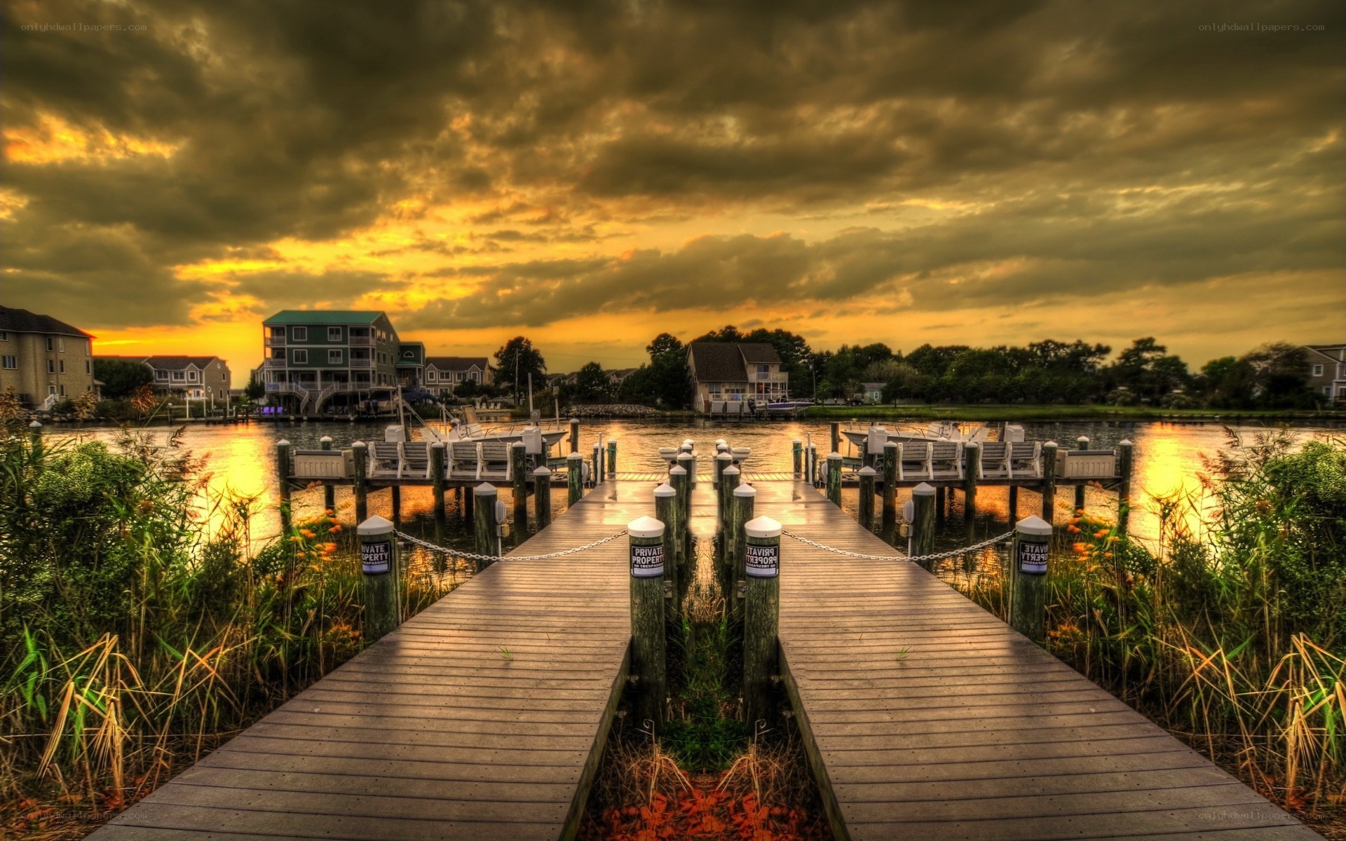 Dock at sunset with houses