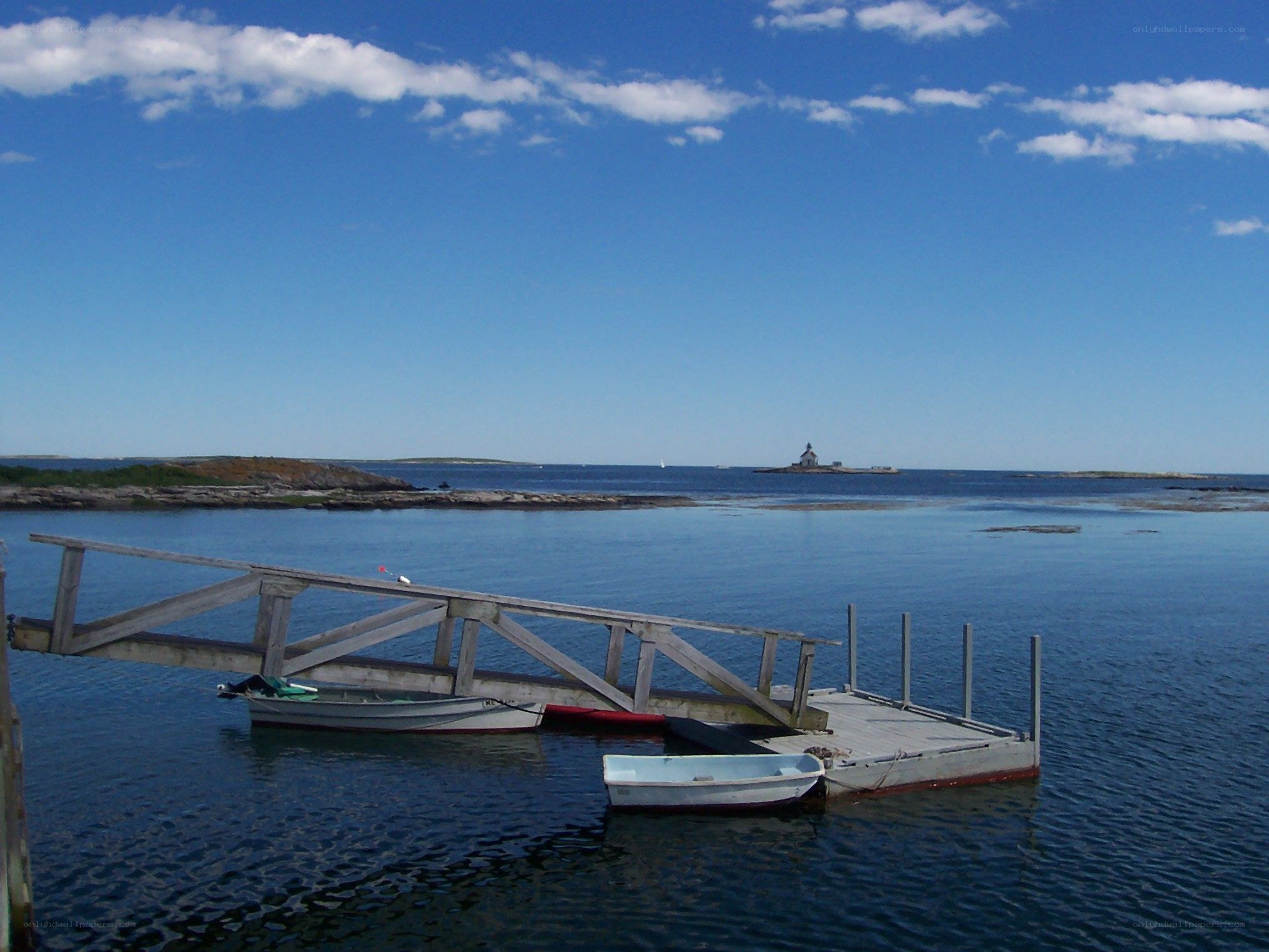 Dock with boats and lighthouse