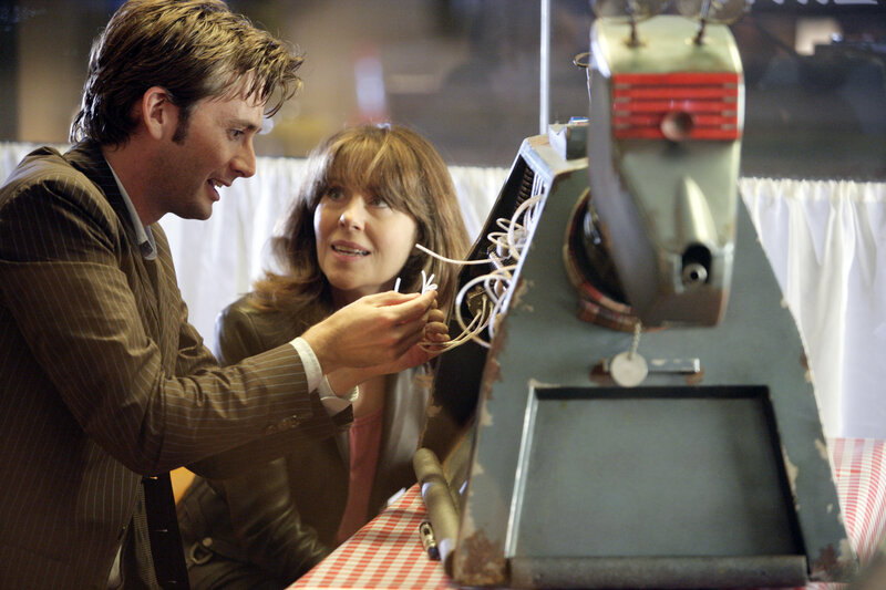 Doctor and companion examining machine