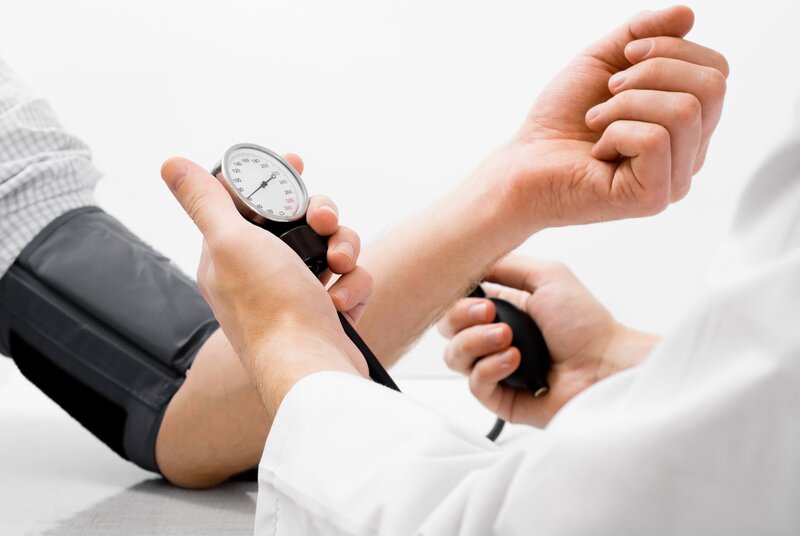Doctor Measuring Blood Pressure — White