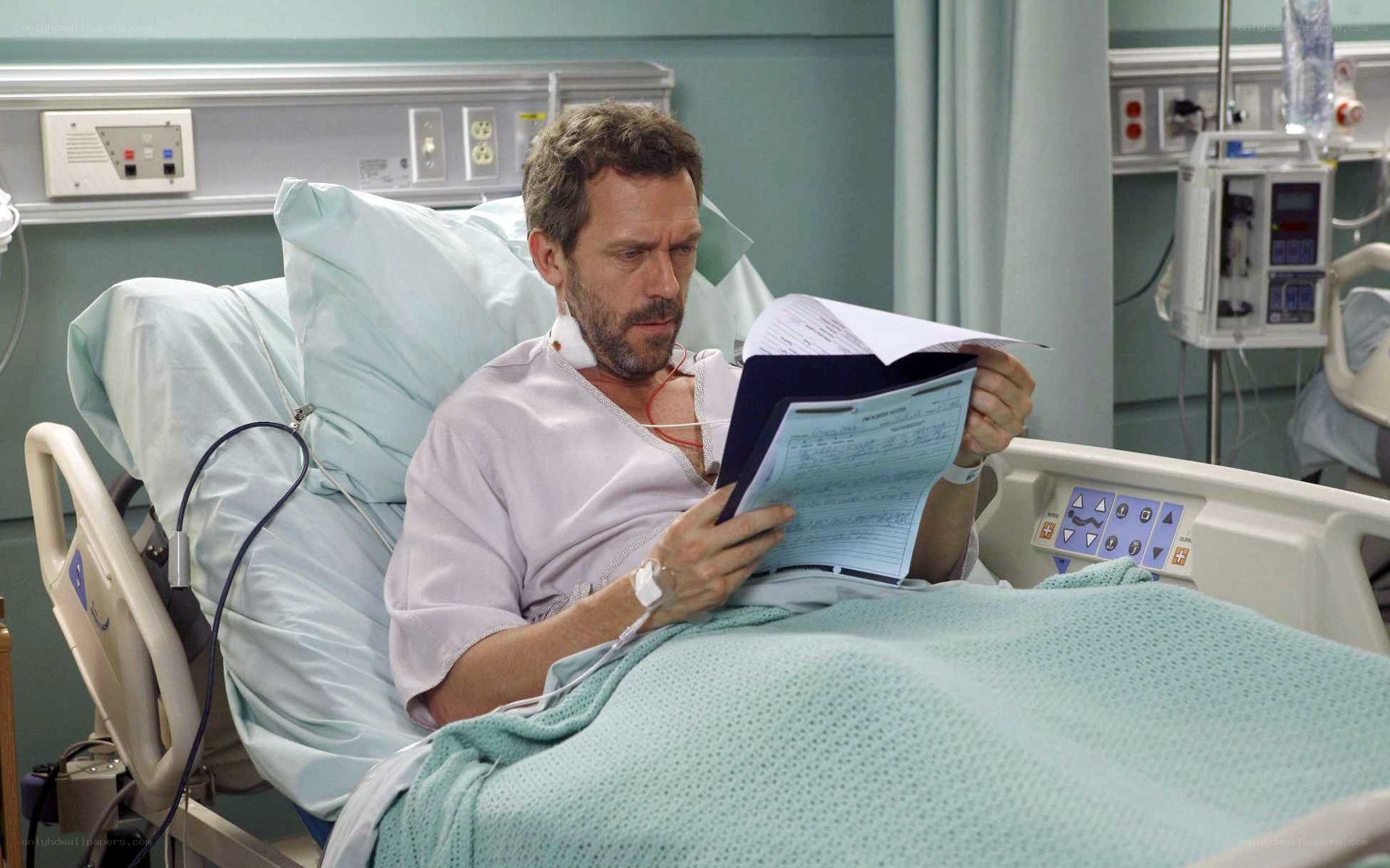 doctor reading in hospital bed