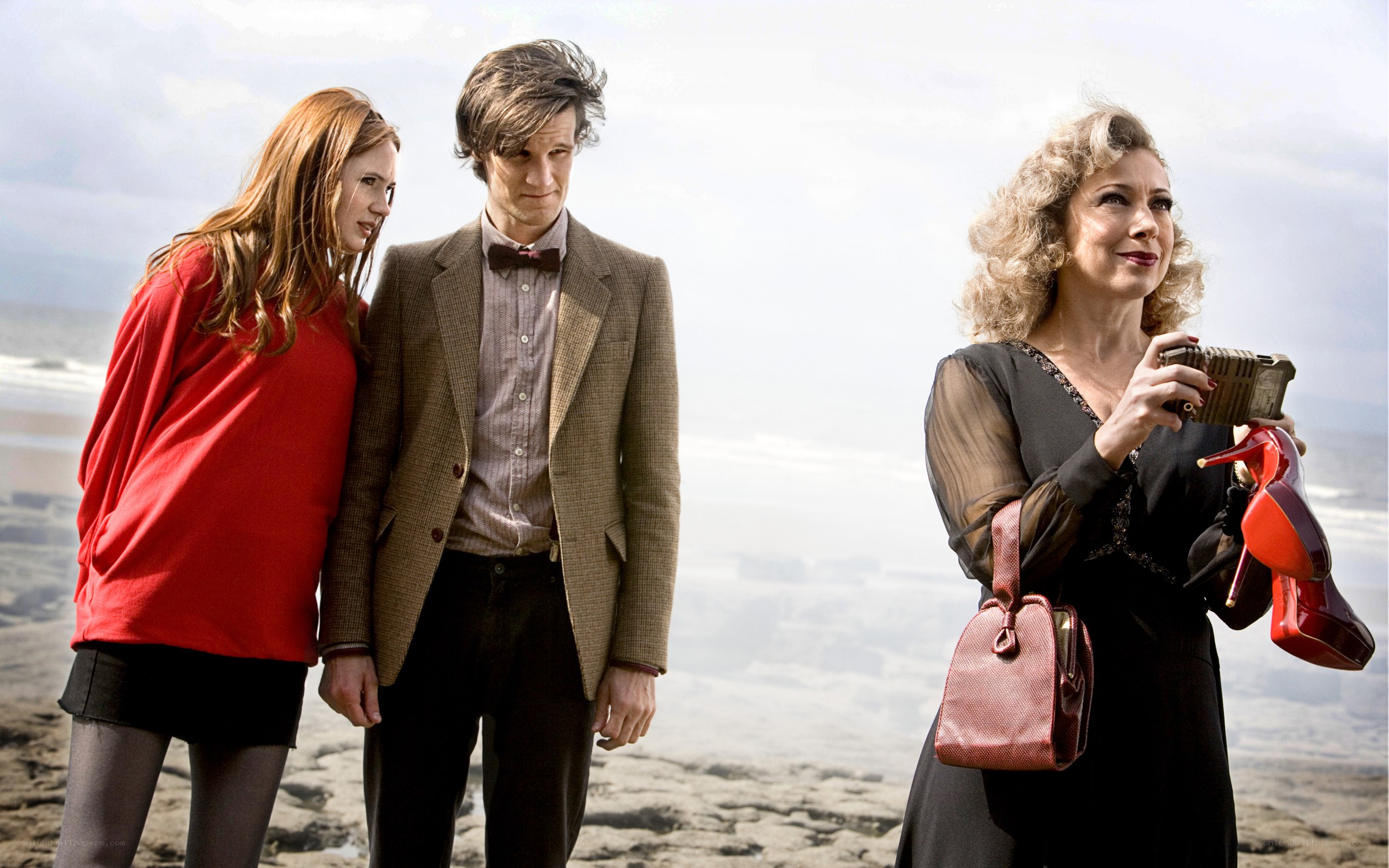 Doctor Who characters on a beach