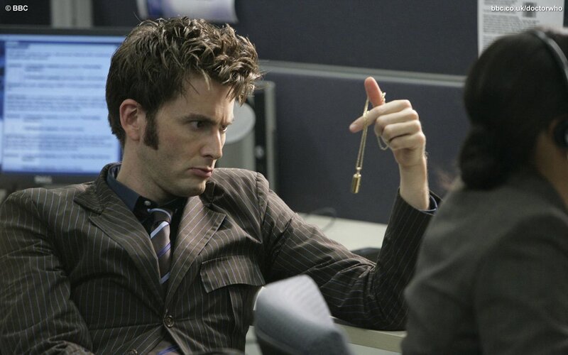 Doctor Who holding a pendant