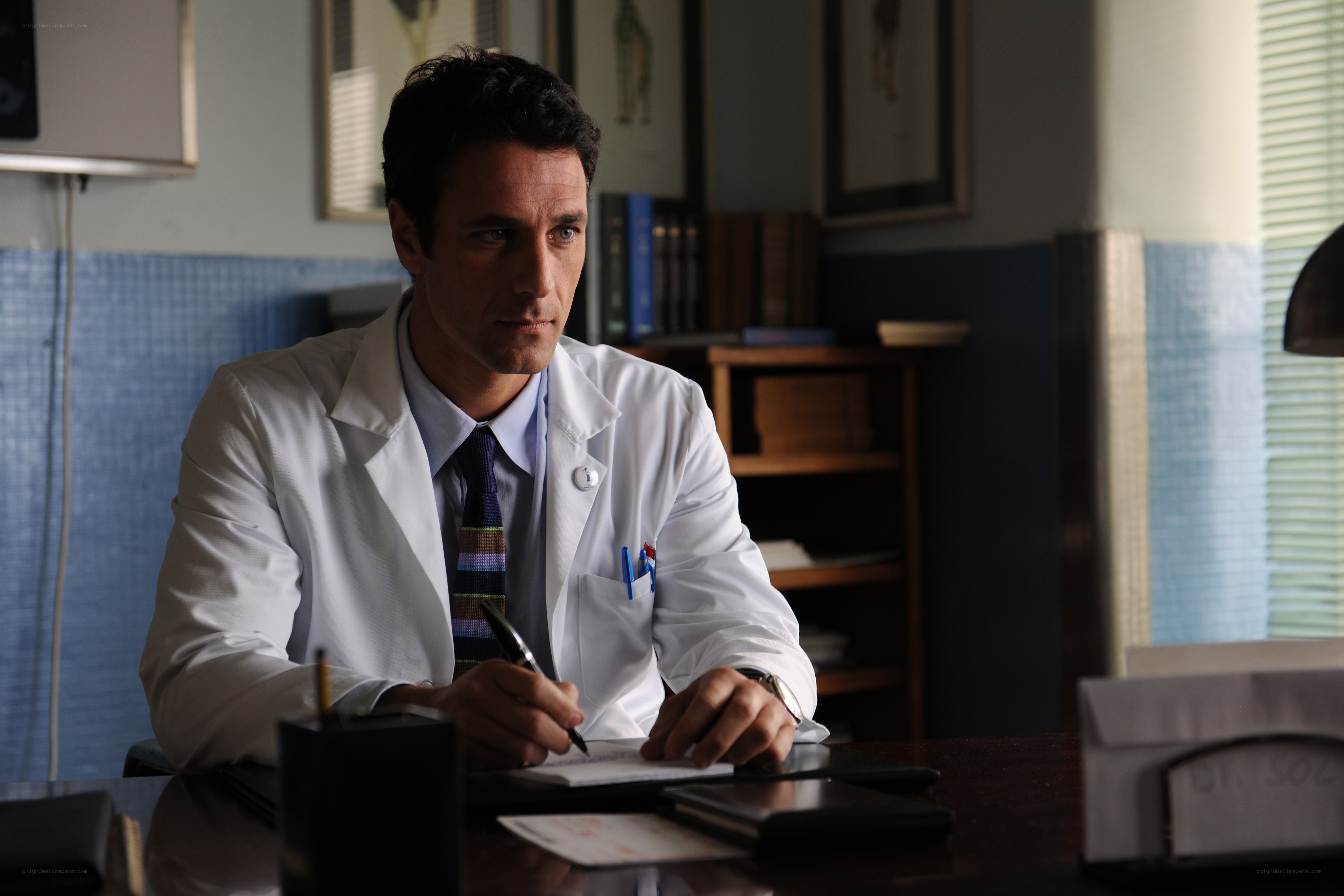 doctor writing at desk