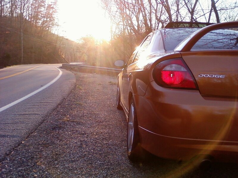 Dodge on a winding road at sunset