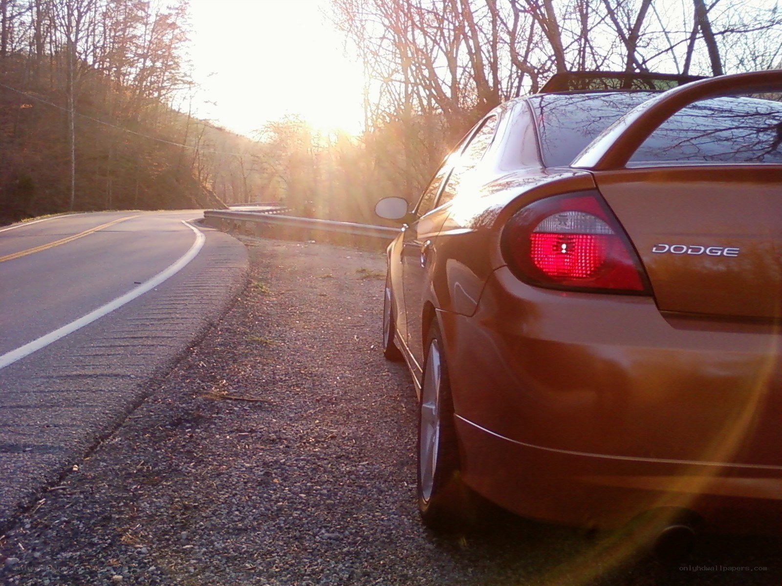 Dodge on a winding road at sunset