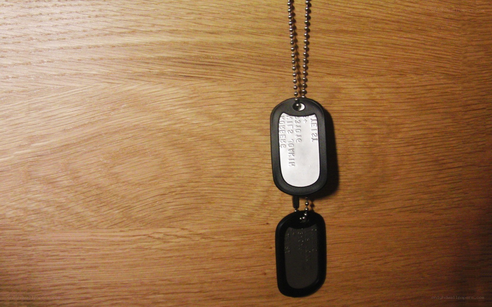 dog tags on wooden surface