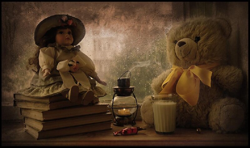 Doll and teddy bear by window