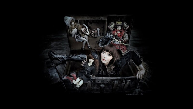 doll collection in a chest