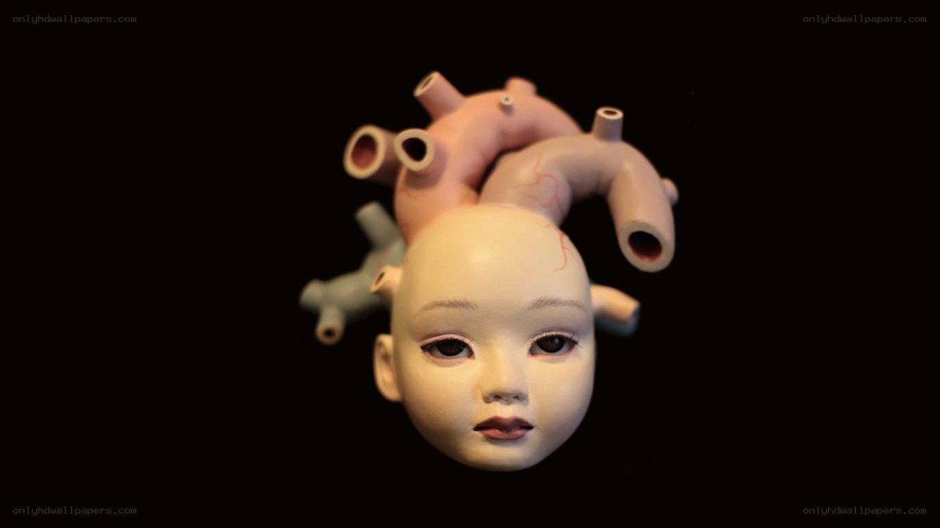 doll head with heart sculpture