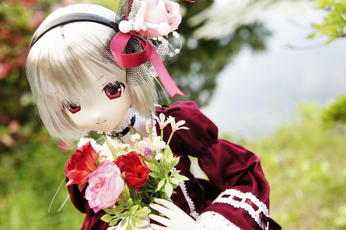 doll holding flowers outdoors