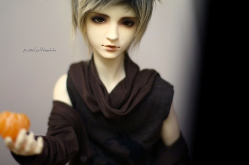 Doll Holding Orange