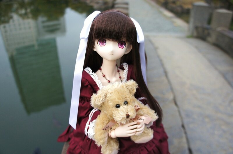 doll holding teddy bear