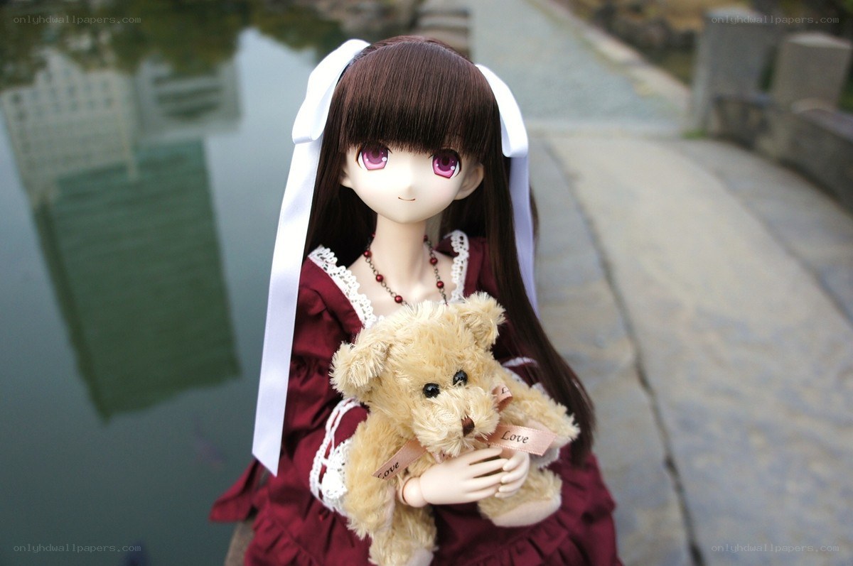 doll holding teddy bear