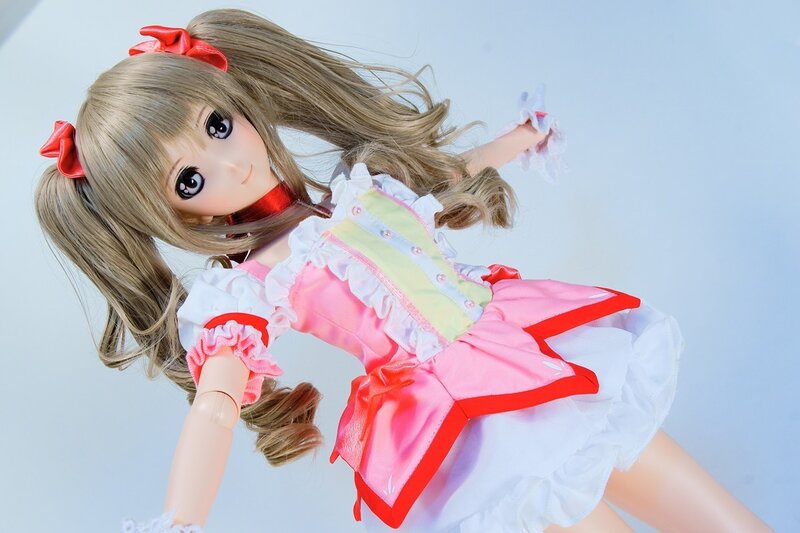 doll in pink and white dress