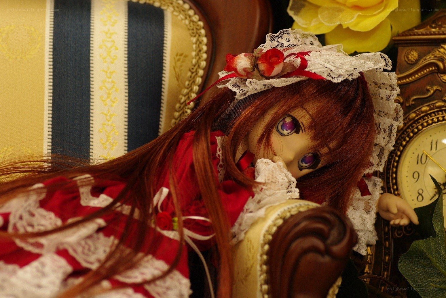 doll in red dress on couch