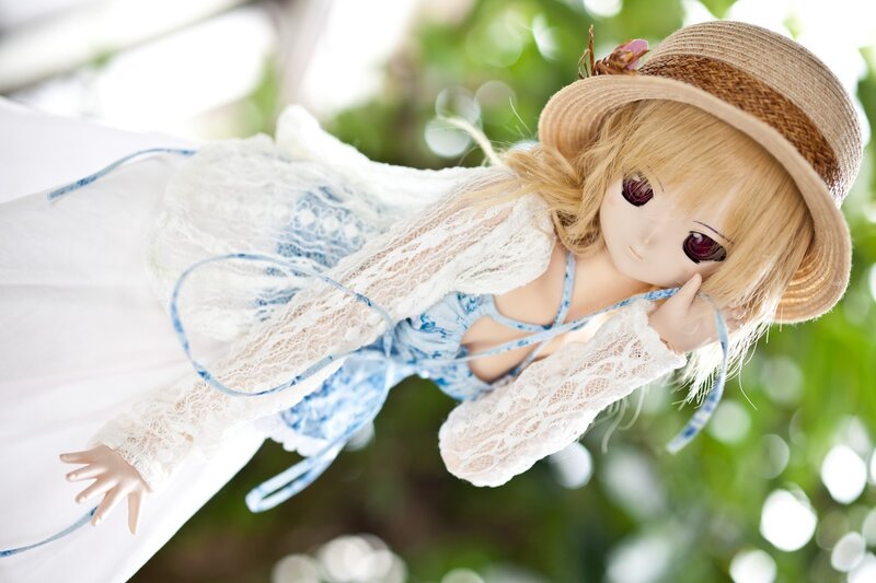 doll in straw hat and lace dress