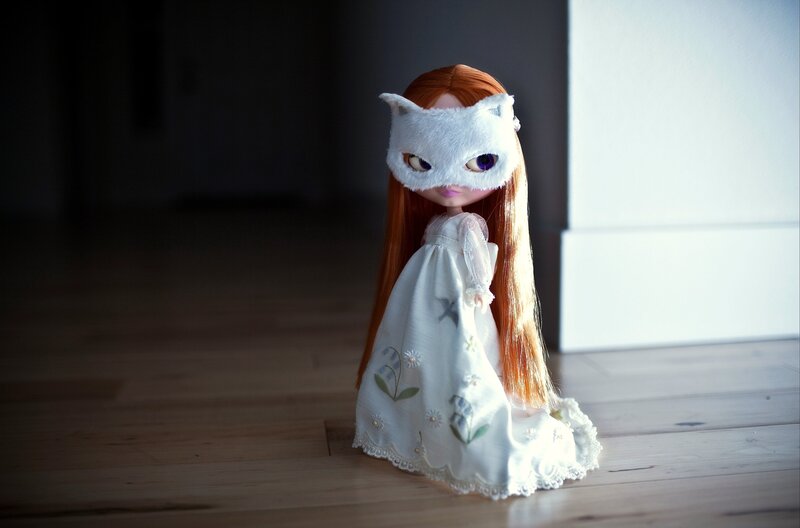 doll in white dress and mask