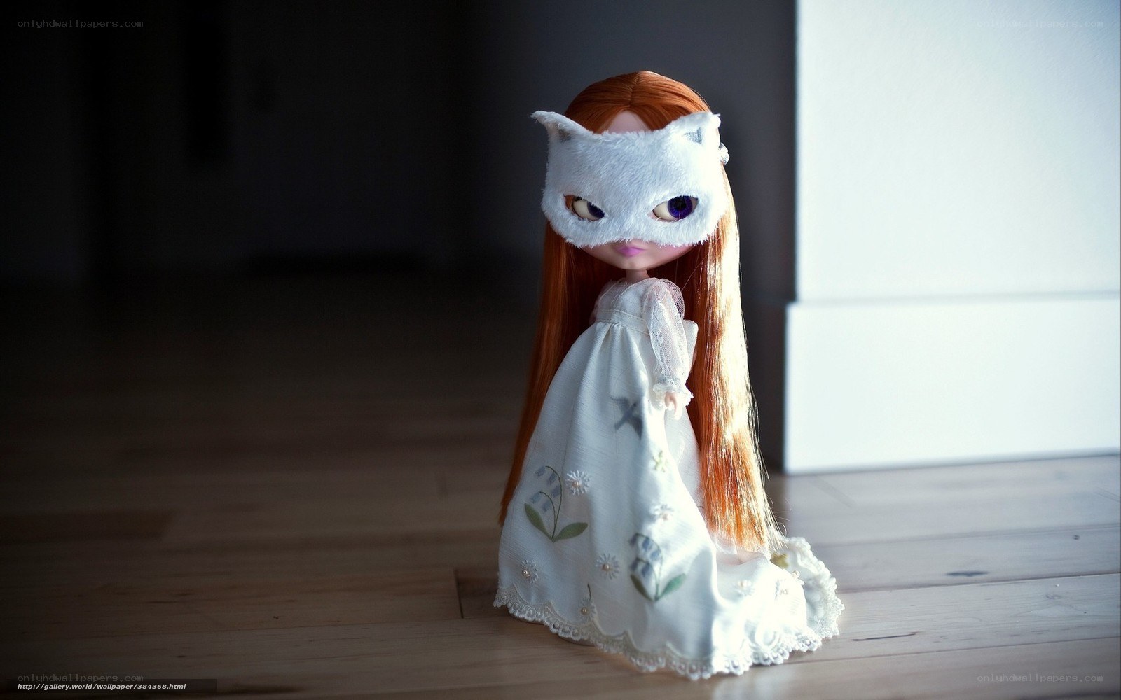 doll in white dress and mask