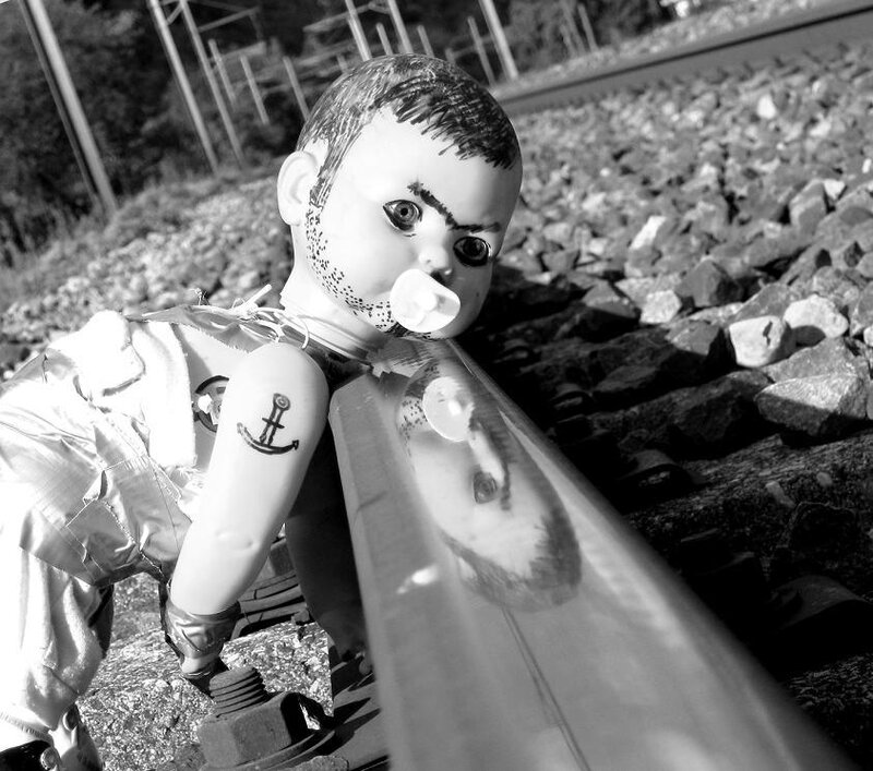 doll on train tracks