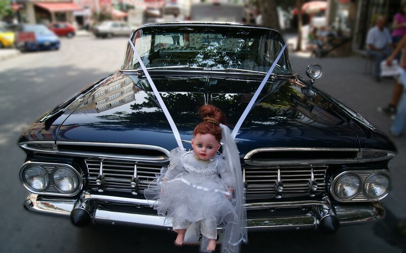 Doll on vintage car hood