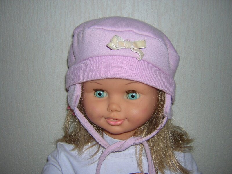 doll wearing pink hat