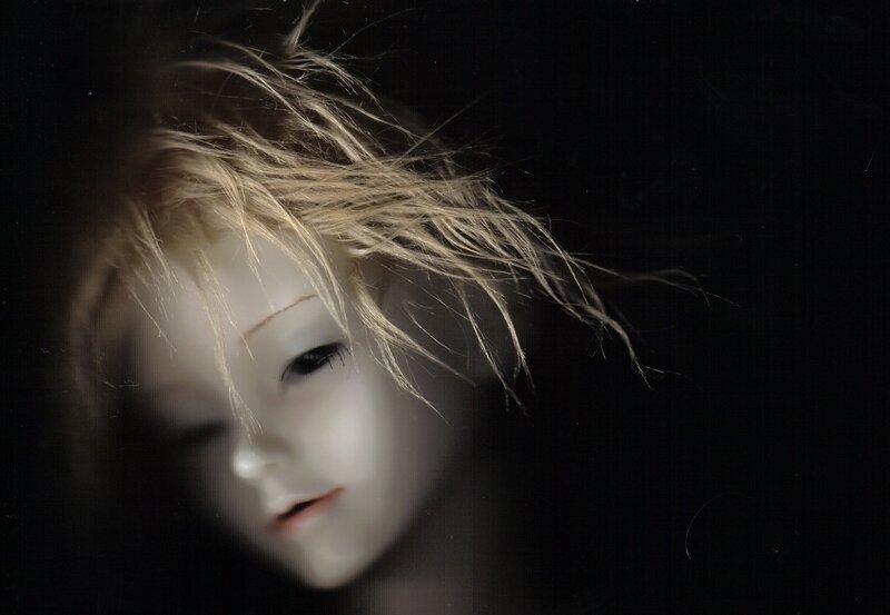 doll with blonde hair in dark