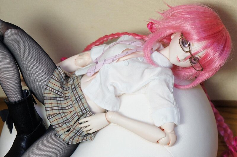 doll with pink hair lying down