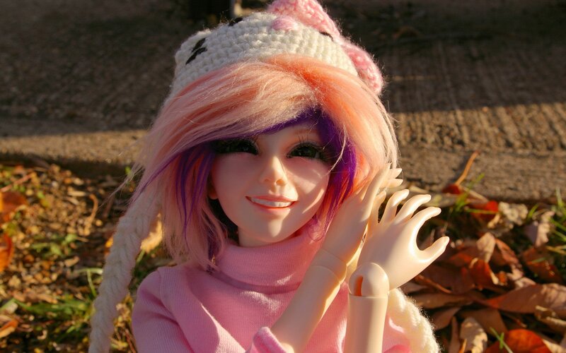 doll with pink hair outdoors