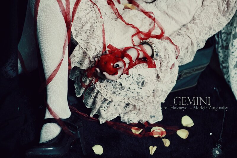 doll with red ribbon