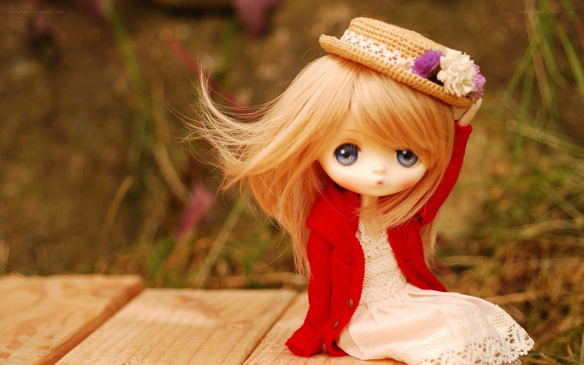 doll with straw hat outdoors